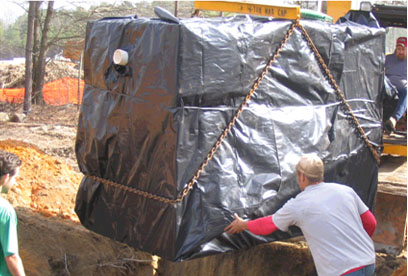 setting tar coated, waterproofed tank